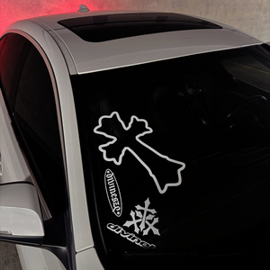 Car window with a white cross decal on a textured gray background