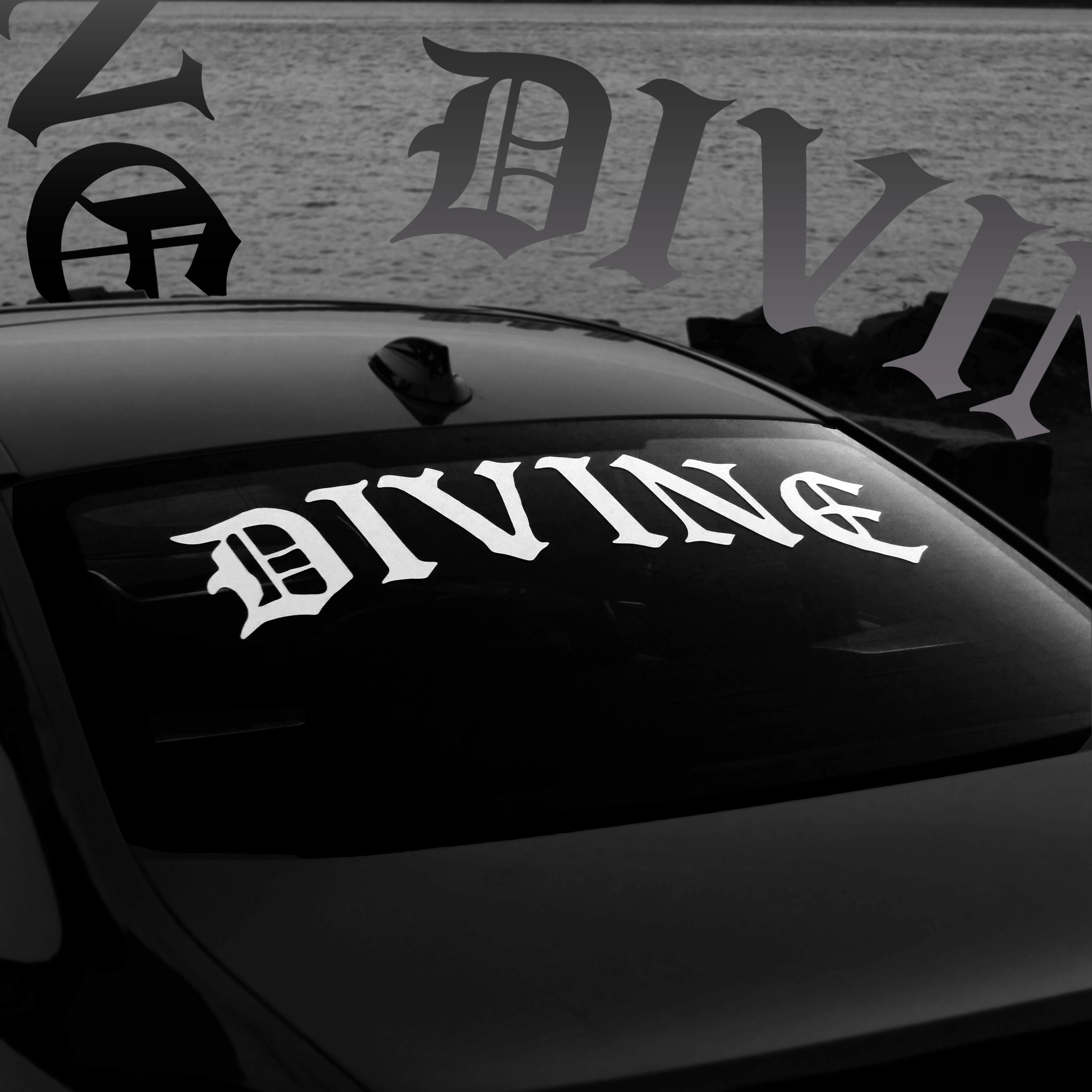 Car window with 'DIVINE' decal and blurred background